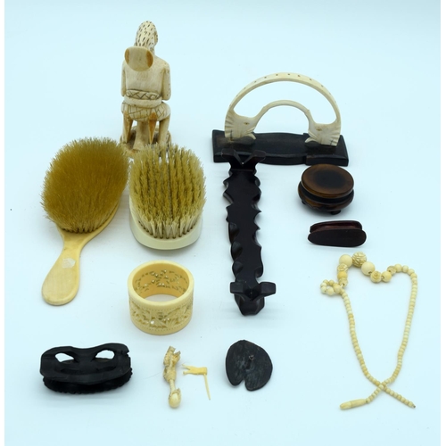 4264 - A collection of Ivory items including sculptures , brushes napkin and necklace Qty.