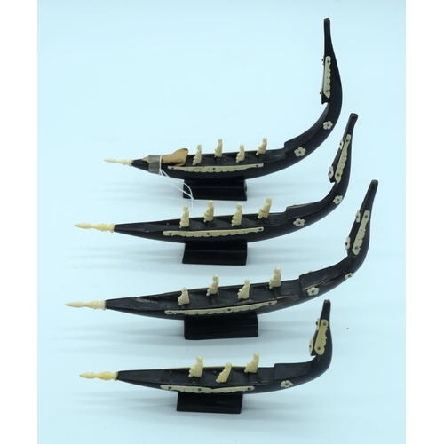 4265 - A group of  carved wooden boats with African Ivory figures 22 cm (4).