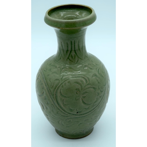 4342 - A Chinese green glazed vase with a floral pattern 24 x 13cm.