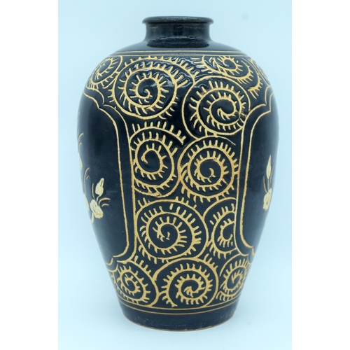 4372 - A song style Cizhou ware vase decorated with black ground  and Ivory flowers. 29cm.