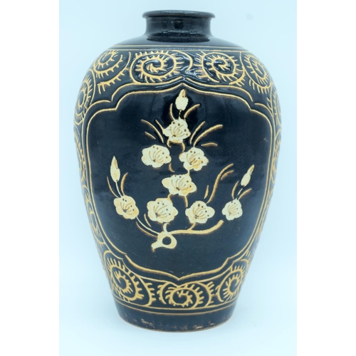 4372 - A song style Cizhou ware vase decorated with black ground  and Ivory flowers. 29cm.