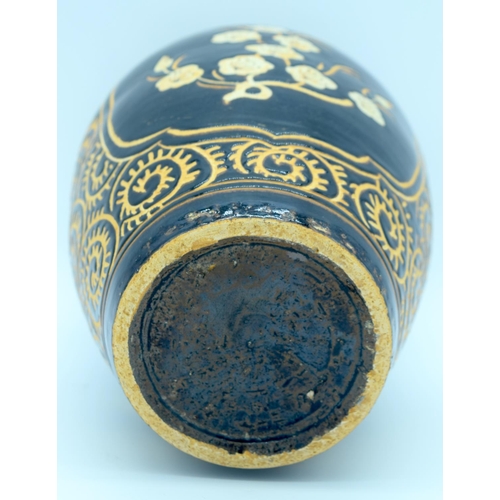 4372 - A song style Cizhou ware vase decorated with black ground  and Ivory flowers. 29cm.