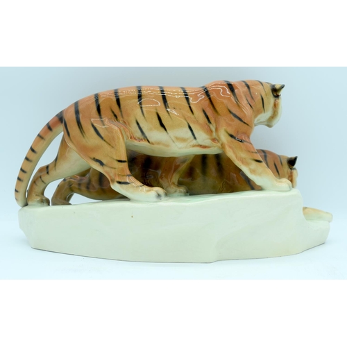 4404 - A German porcelain figure of two tigers 43 x 18cm.