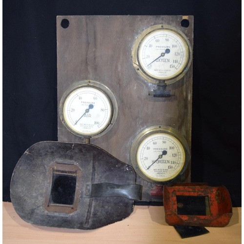 4421 - Collection of vintage welding equipment including masks and mounted brass cased Gauges