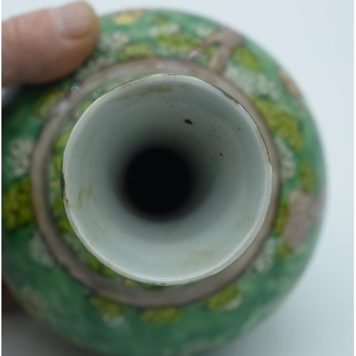 4435 - A Chinese green glaze vase decorated with kite flyers 19cm.