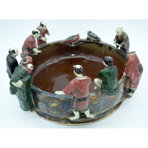 4469 - A large Japanese Sumida Gawa pottery bowl with figures peering into the bowl 38 x 18cm.