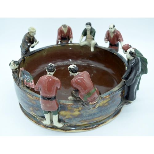 4469 - A large Japanese Sumida Gawa pottery bowl with figures peering into the bowl 38 x 18cm.