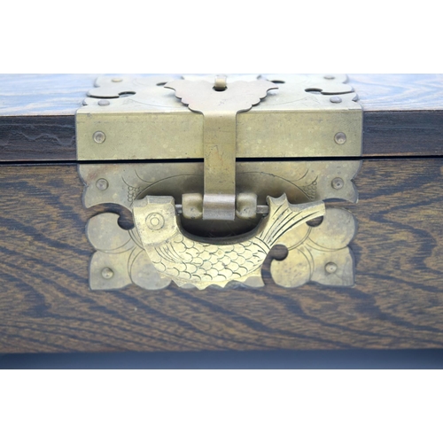 4472 - A wooden Chinese box with brass fittings and a fish lock and a calligraphy paper lining 32 x 22cm