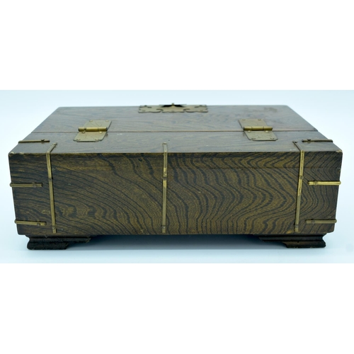 4472 - A wooden Chinese box with brass fittings and a fish lock and a calligraphy paper lining 32 x 22cm