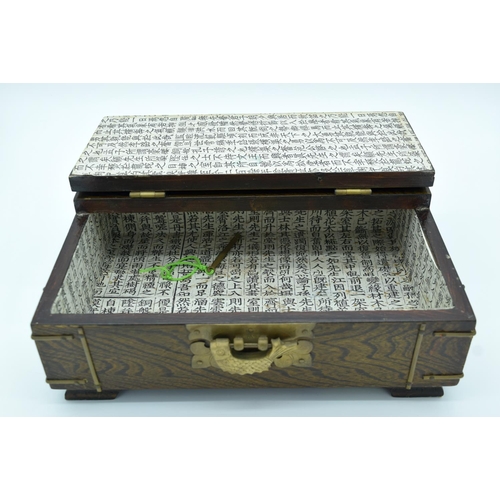 4472 - A wooden Chinese box with brass fittings and a fish lock and a calligraphy paper lining 32 x 22cm