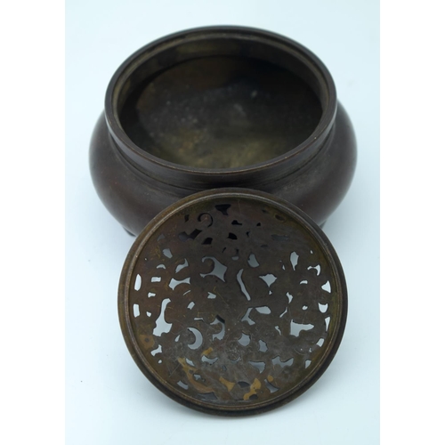 4483 - A small Chinese bronze censer with an openwork lid 10 x 7cm.