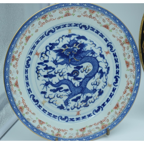 4485 - A Chinese Lacquered dish together with a Chinese Blue and white dragon plate and another 34cm .(3)