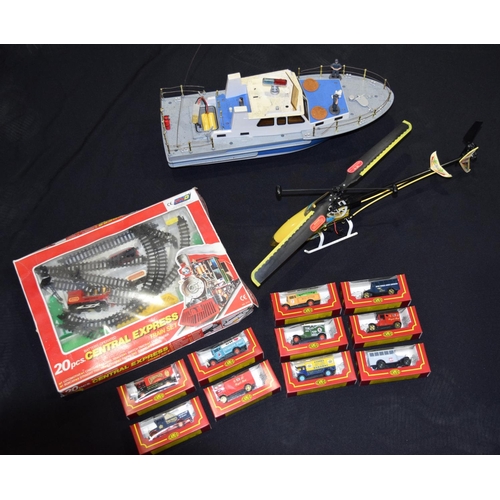 4563 - A radio controlled helicopter and  Boat  together with other models including corgi trucks