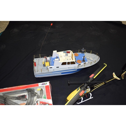 4563 - A radio controlled helicopter and  Boat  together with other models including corgi trucks