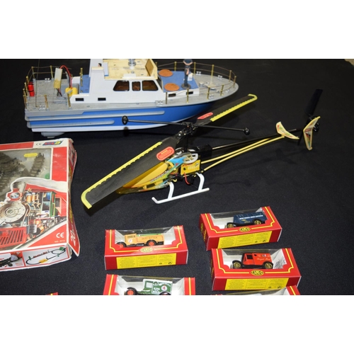 4563 - A radio controlled helicopter and  Boat  together with other models including corgi trucks