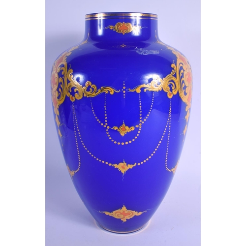 6 - A LARGE TURKISH OTTOMAN BLUE GLASS VASE enamelled with motifs. 39 cm x 18 cm.