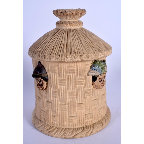 697 - AN ANTIQUE AUSTRIAN TOBACCO JAR AND COVER in the form of heads within a hut. 19 cm high.