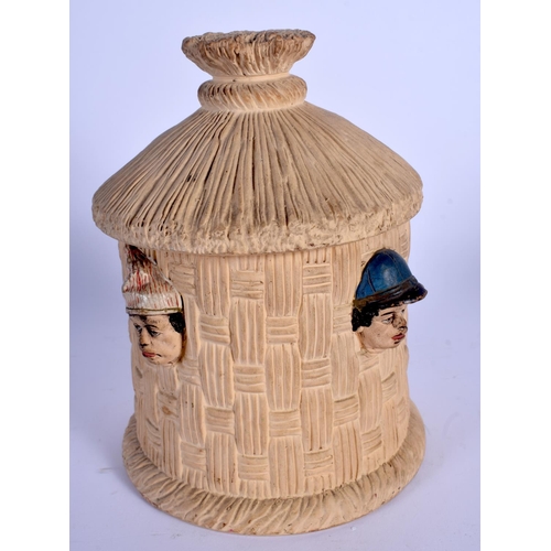 697 - AN ANTIQUE AUSTRIAN TOBACCO JAR AND COVER in the form of heads within a hut. 19 cm high.