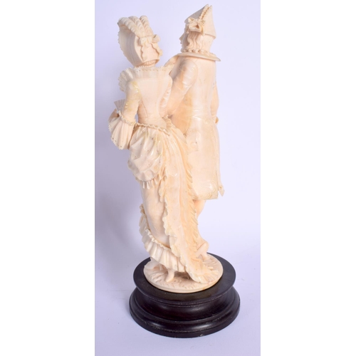 724 - A FINE 19TH CENTURY EUROPEAN DIEPPE IVORY FIGURE OF A DANDY modelled with a female, upon a wooden pl... 