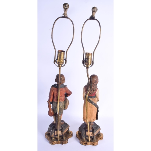 753 - A PAIR OF 19TH CENTURY AUSTRIAN TERRACOTTA FIGURES converted to lamps. Figure 33 cm high.