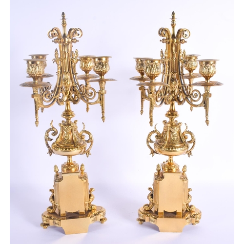 755 - A PAIR OF 19TH CENTURY FRENCH BRONZE CANDLESTICKS formed with paw feet and acanthus. 43 cm x 15 cm.