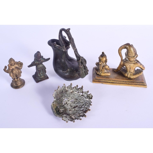 760 - AN EARLY INDIAN BRONZE EWER together with other Hindu bronzes. Largest 9 cm x 11 cm. (5)