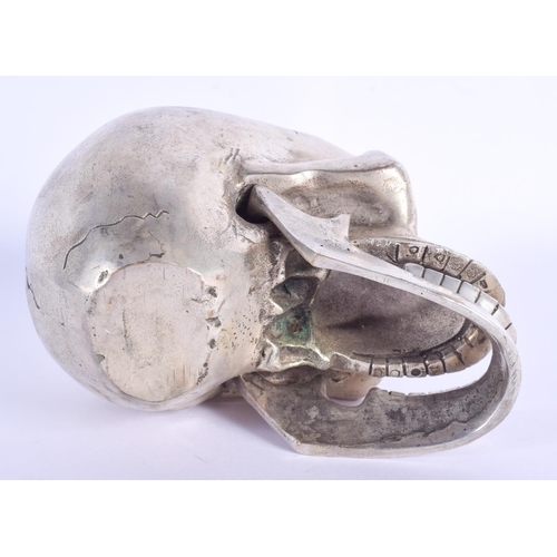 770 - A CONTEMPORARY SILVER PLATED SKULL. 11 cm x 9 cm.