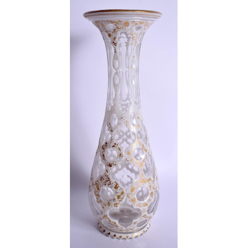 11 - A 19TH CENTURY BOHEMIAN WHITE OVERLAID VASE painted with gilt and foliage. 32 cm high.