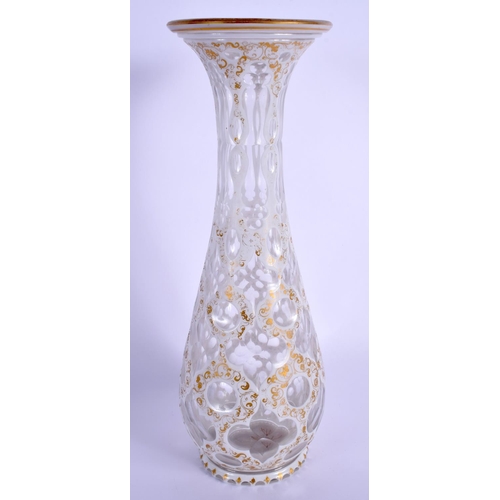 11 - A 19TH CENTURY BOHEMIAN WHITE OVERLAID VASE painted with gilt and foliage. 32 cm high.