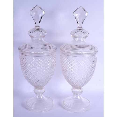 14 - A PAIR OF CUT GLASS STORM LAMPS AND COVERS. 53 cm high.