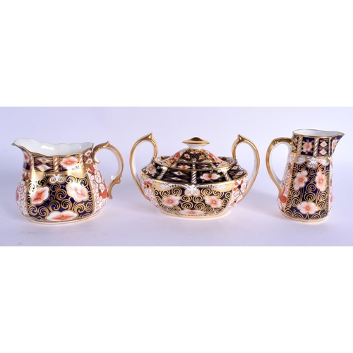 141 - Royal Crown Derby imari pattern 2451 boat shaped sugar bowl and cover, a milk jug and cream jug.  Bo... 