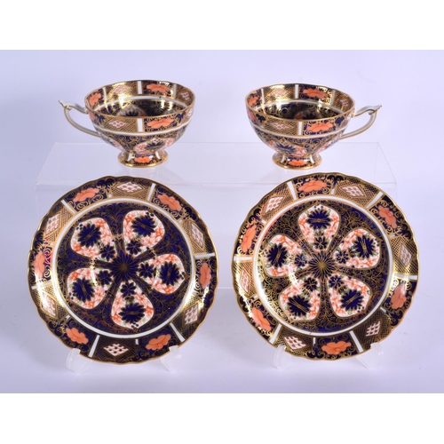 145 - Royal Crown Derby imari  pattern 1128  two pedestal cups and saucers.  Cup 5.5cm high, Saucer 14cm w... 