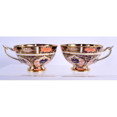 146 - Royal Crown Derby imari pattern 1128 two pedestal cups and saucers.  Cup 5.5cm high, Saucer 14cm wid... 