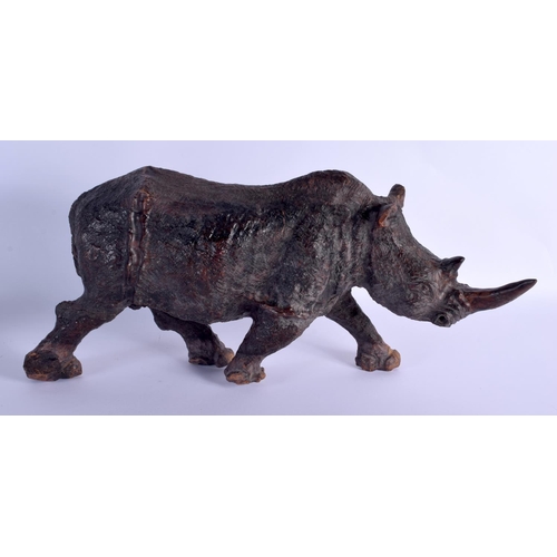 259 - A LARGE VINTAGE CARVED AFRICAN WOOD FIGURE OF A ROAMING RHINOCEROS modelled upon all fours. 45 cm x ... 