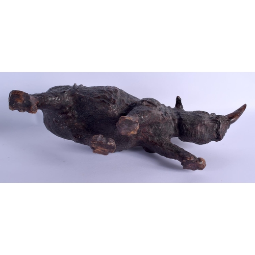 259 - A LARGE VINTAGE CARVED AFRICAN WOOD FIGURE OF A ROAMING RHINOCEROS modelled upon all fours. 45 cm x ... 