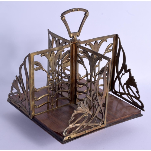 273 - AN ART NOUVEAU BRASS AND HARDWOOD SPINNING STAND upon a square form base. 23 cm x 32 cm.