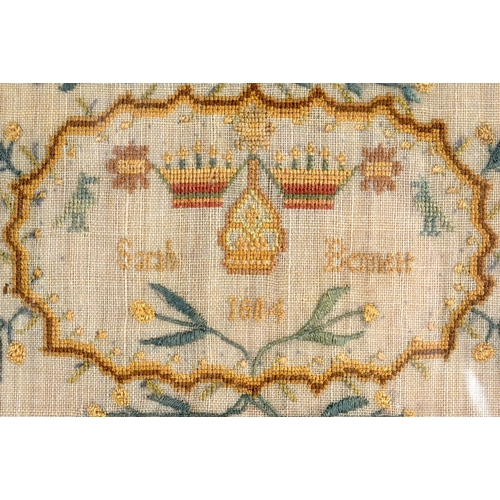 299 - A 19TH CENTURY ENGLISH EMBROIDERED SAMPLER by Sarah Bennett. Image 42 cm x 28 cm.