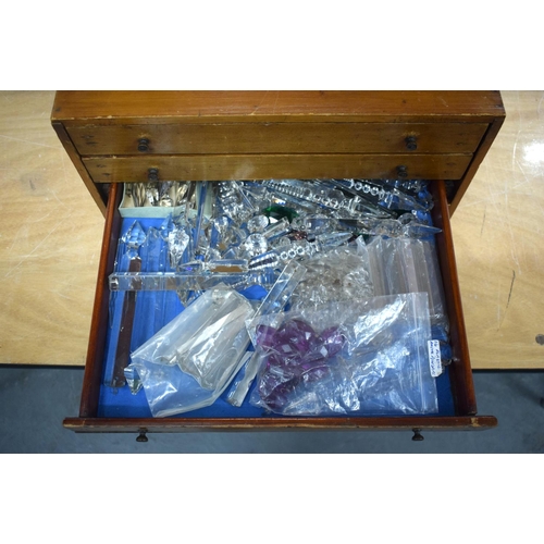 300 - AN 1950S PINE SPECIMEN OF WATCH MAKERS CHEST containing numerous cut glass prism drops etc. Box 27 c... 