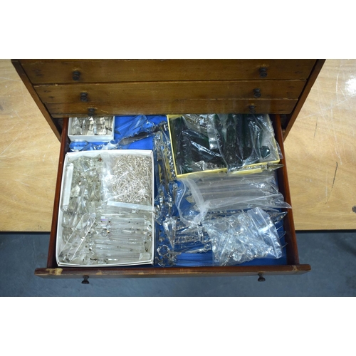 300 - AN 1950S PINE SPECIMEN OF WATCH MAKERS CHEST containing numerous cut glass prism drops etc. Box 27 c... 