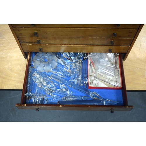 300 - AN 1950S PINE SPECIMEN OF WATCH MAKERS CHEST containing numerous cut glass prism drops etc. Box 27 c... 