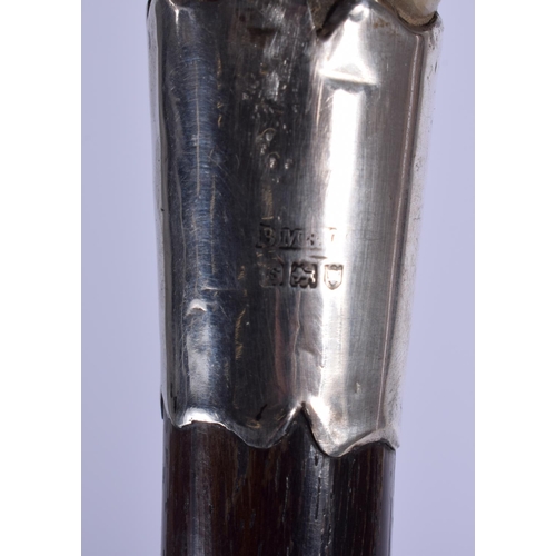 304 - A 19TH CENTURY CONTINENTAL CARVED BUFFALO HORN WALKING CANE with silver mounts. 88 cm long.