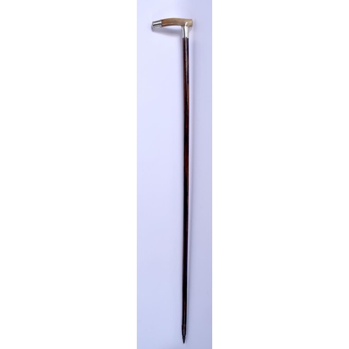 304 - A 19TH CENTURY CONTINENTAL CARVED BUFFALO HORN WALKING CANE with silver mounts. 88 cm long.