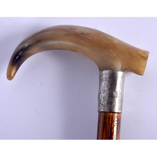 309 - A 19TH CENTURY CONTINENTAL CARVED BUFFALO HORN WALKING CANE with silver mounts. 88 cm long.