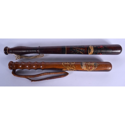 318 - TWO 19TH CENTURY PAINTED WOOD TRUNCHEON one stamped M Norton of Glasgow. Largest 46 cm long. (2)