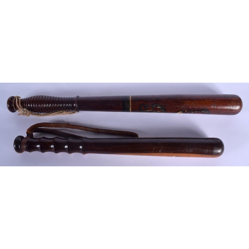 318 - TWO 19TH CENTURY PAINTED WOOD TRUNCHEON one stamped M Norton of Glasgow. Largest 46 cm long. (2)