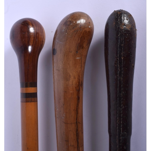 339 - AN ANTIQUE MULTI CARVED HARDWOOD SWAGGER STICK together with two others. Largest 84 cm long. (3)