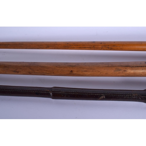 339 - AN ANTIQUE MULTI CARVED HARDWOOD SWAGGER STICK together with two others. Largest 84 cm long. (3)