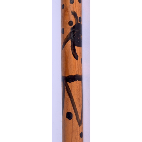 342 - AN UNUSUAL EARLY 20TH CENTURY PAINTED WOOD WALKING CANE with dimple decoration. 84 cm long.