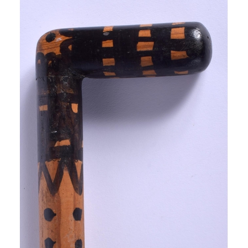 342 - AN UNUSUAL EARLY 20TH CENTURY PAINTED WOOD WALKING CANE with dimple decoration. 84 cm long.