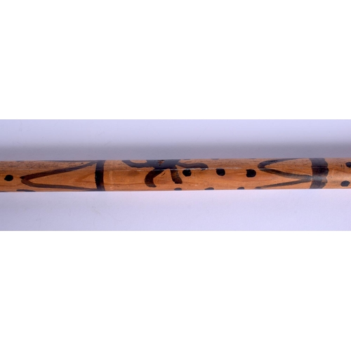 342 - AN UNUSUAL EARLY 20TH CENTURY PAINTED WOOD WALKING CANE with dimple decoration. 84 cm long.